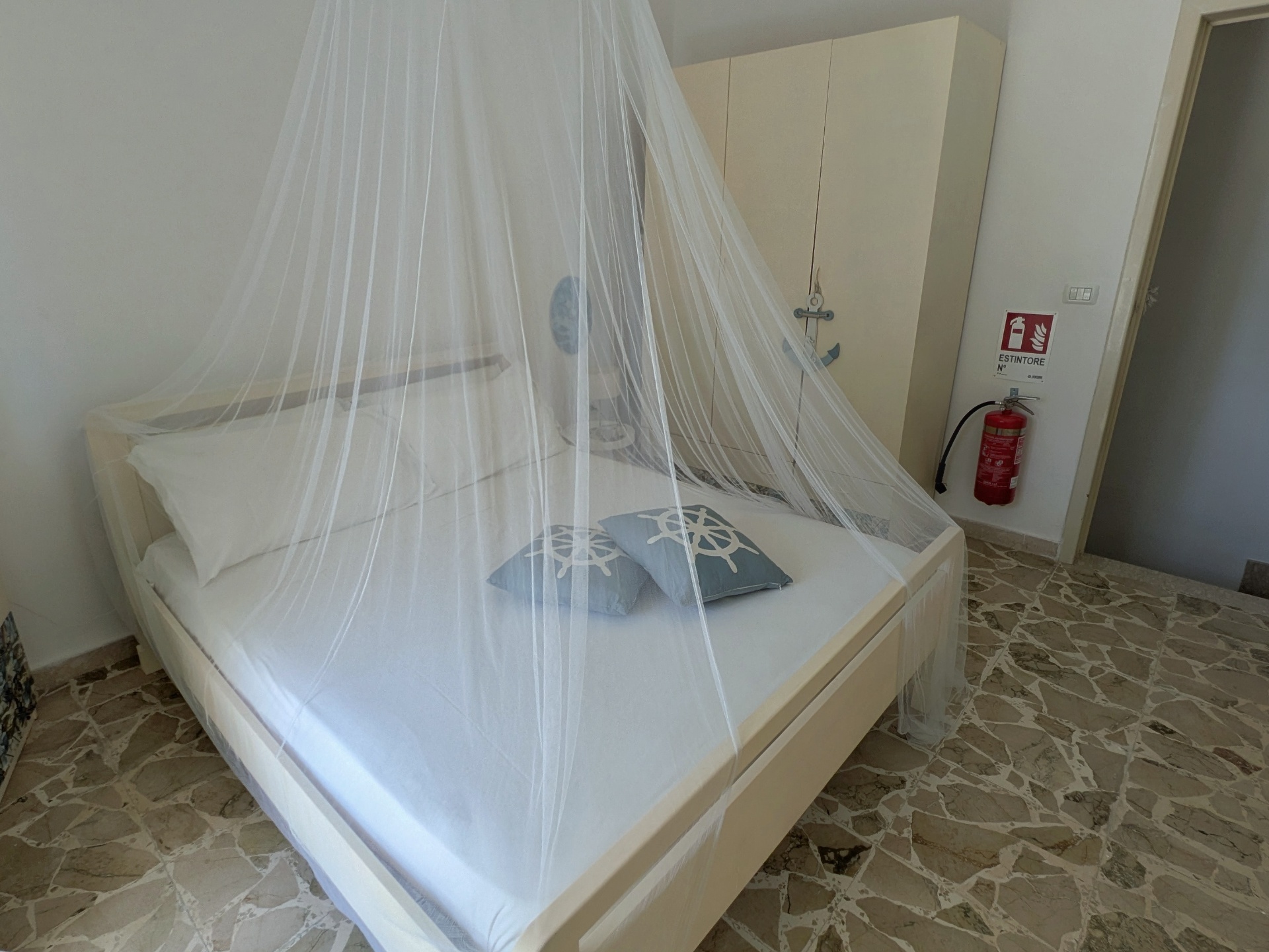 Master bedroom in nautical style with mosquito net